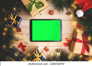 Green Screen Tablet Device Between Christmas Decoration. Top View
