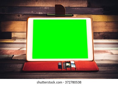 Green screen tablet pc on the wooden background - Powered by Shutterstock