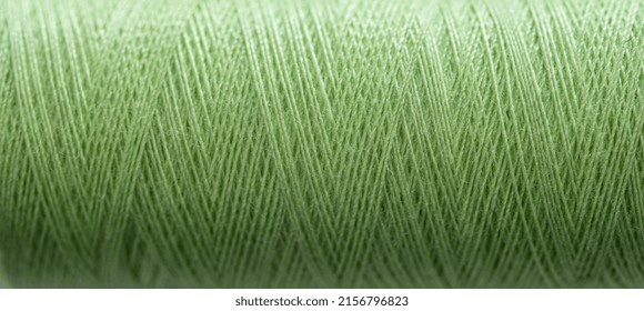 Green Sewing Thread In Spool For Sew Hobby Closeup. Macro Bobbin View For Needlework