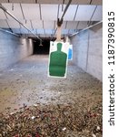 Green shooting range target over a lot of empty cartridge. Firearm ammunition, empty bullet, shots or slug.