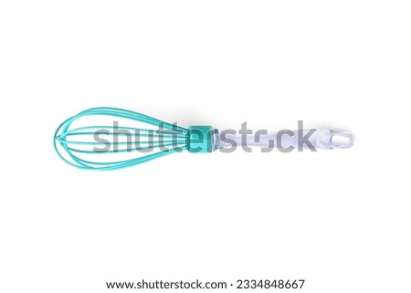 Green silicone whisk on a white background. Top view.