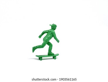 Green skateboard toy figure isolated