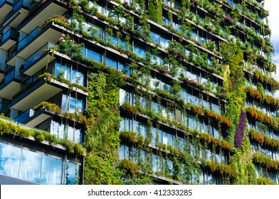 Green skyscraper building with plants growing on the facade. Ecology and green living in city, urban environment concept. Park in the sky, One central park building, Sydney, Australia