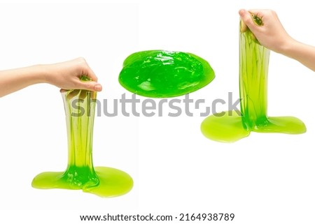 Green slime toy in woman hand isolated on white.