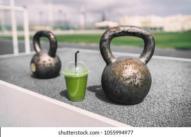 Green Smoothie Detox At Gym With Kettlebell Weights.