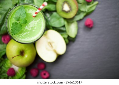 green smoothie with fruits and vegetables on black background - Powered by Shutterstock