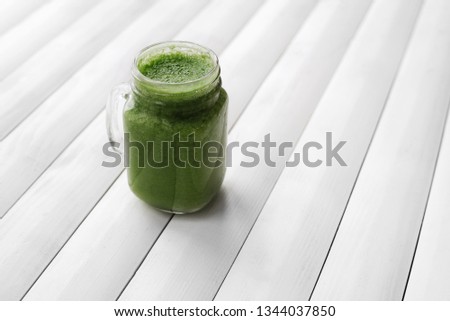 Similar – Foto Bild Grünkohl Smoothie im Glas auf weißem Holzgrund.