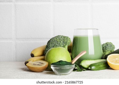 Green Smoothie In Glass, Spirulina Powder, Vegetables And Fruits On White Ceramic Tile Background. Healthy, Raw, Vegan Diet Concept. Copy Space