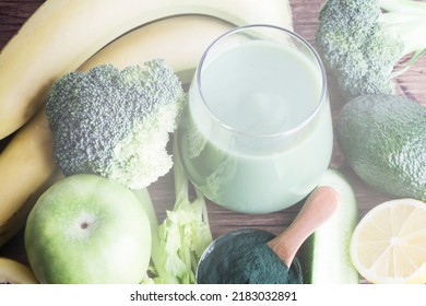 Green Smoothie In Glass, Spirulina Powder, Vegetables And Fruits On Wooden Background. Healthy, Raw, Vegan Diet Concept. 