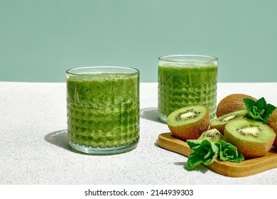 Green smoothie with kiwi fruit in the glasses. Healthy organic drink. Nutrition and alkaline diet. Healthie eating vegetarian concept. - Powered by Shutterstock