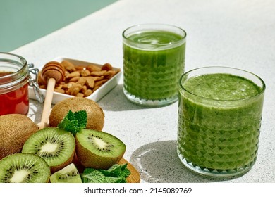 Green smoothie with kiwi fruit in the glasses. Healthy organic drink. Nutrition and alkaline diet. Healthie eating vegetarian concept.