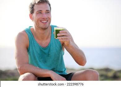 Green smoothie man drinking vegetable juice after running sport fitness training. Healthy eating lifestyle concept with young man outdoors. - Powered by Shutterstock