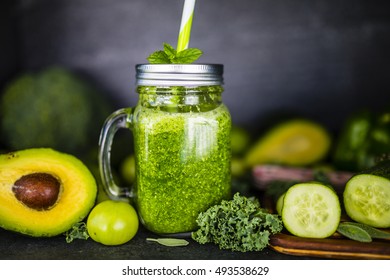 Green smoothie in a mason jar mug on dark stone background. Healthy food and detox. - Powered by Shutterstock