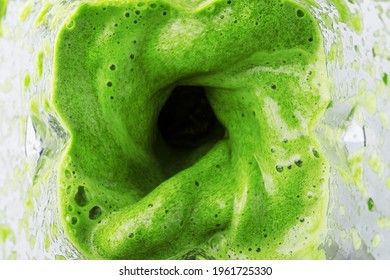 Green Smoothie Mixed In A Blender Bowl, Top View. The Concept Of Delicious And Healthy Food.