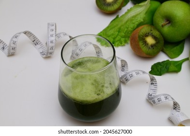 Green smoothie on the background of ingredients. healthy drink for proper nutrition. sugarless. diet, weight control, weight loss.apples,parsley, pinach, cucumber, lime and mint. detox program