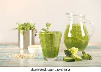 a green smoothie is on the table next to healthy foods - Shutterstock ID 1807645816
