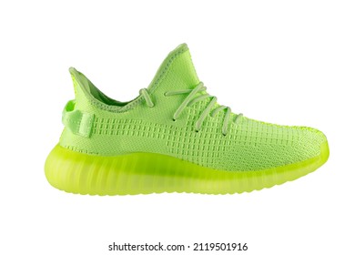 Green sneaker with a polyurethane sole on a white background.