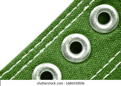 Green Sneakers Background. Silver Metal Shine Shoe Eyelet Grommet. White Sew Thread Fabric Texture. Empty Copy Space Fashion Background.