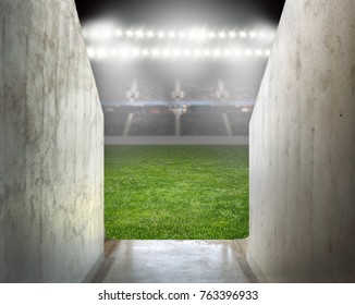 Green Soccer Field Empty With Row Of Bright Spotlights Illuminating The Stadium In Night At Arena Tunnel 