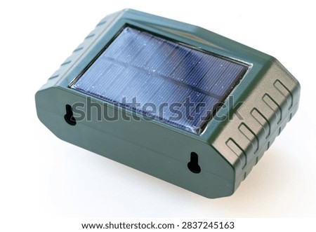 A green solarpowered device with a panel is shown on a white background