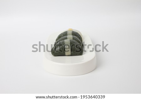 green Song pyeon which is Korean rice cake on a white plate