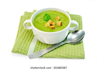 Green Soup Puree In A Bowl With Croutons And Spinach Leaf On A Napkin Isolated On White Background