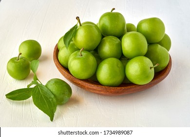 Green Sour Plum In Wooden Bowl