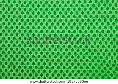green special textile mesh background. Polyester mesh with foam rubber for the manufacture of backpacks. Lining mesh with foam for the inside of a bag or clothes.