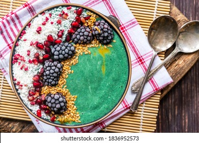 Green Spirulina Smoothie Bowl With Fruit And Linseed - Healthy Superfood Breakfast Idea. Overhead View