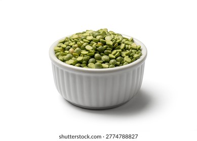 Close‑up of green split peas in a ribbed ceramic bowl on a white background, showing natural texture and vibrant color typical of dried legumes used in soups and stews