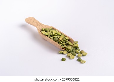 Green Split Peas In A Wooden Measuring Spoon On White Background ( Used For Dutch Pea Soup)