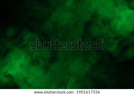 Green steam on a black background. Copy space.