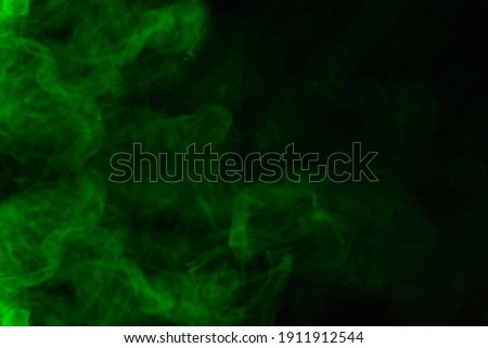 Green steam on a black background. Copy space.