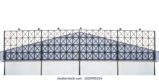 The Green Steel Structure Of An Empty Billboard Frame Is Installed In Front Of The Factory With An Aluminum Sheet Roof. 
For Rent. Isolated On White Background