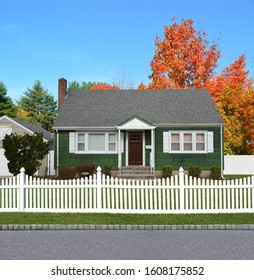 Green Suburban Bungalow Home White Picket Fence Clear Blue Sky Autumn Day