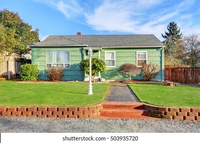 Green Suburban Bungalow style home on blue sky background. Northwest, USA