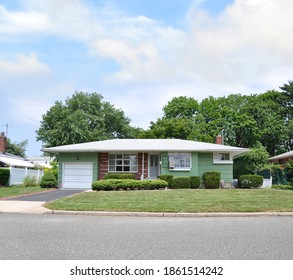 Green Suburban Ranch House With Bricks Blue Sky Clouds