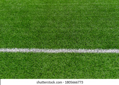 Green Synthetic Grass Sports Field With White Line Shot From Above. Soccer, Rugby, Football, Baseball Sport Concept