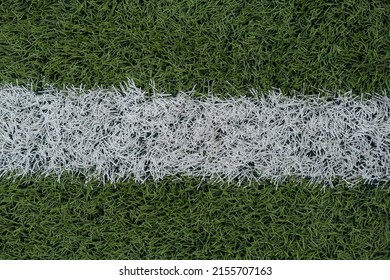 Green Synthetic Grass Sports Field With White Line Shot From Above. Sports Background For Product Display, Banner, Or Mockup. High Quality Photo