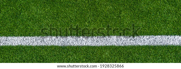 Green synthetic grass sports field with white
line shot from above. Sports background for product display,
banner, or mockup
