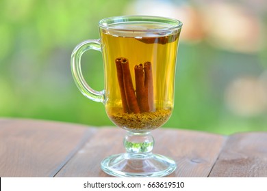 Green Tea With Cinnamon On Nature Background