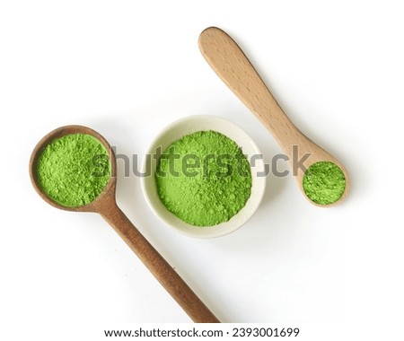 Green tea matcha powder in measuring spoons and cup or bowl         