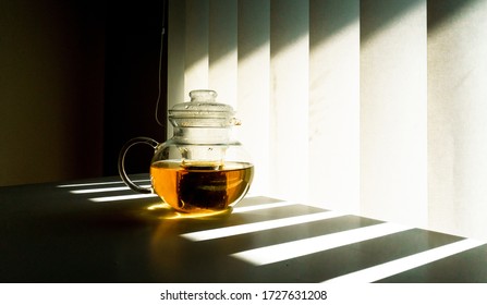 Green Tea Pot Under The Under Light Shadow Line Through Blind Shutter Window.