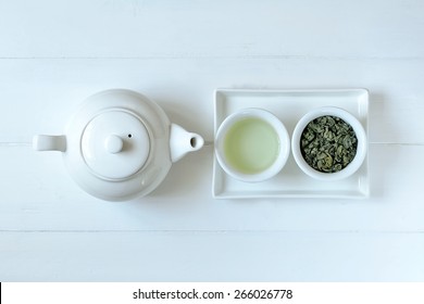 Green Tea In Tea Pot And White Cups, Top View