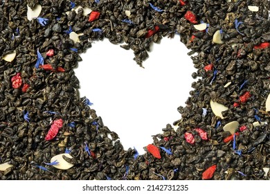 Green tea with raspberry, goji berries, knapweed petals and sliced almonds on white background. Heart shaped. Top view. Close up. High resolution.