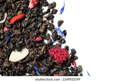 Green tea with raspberry, goji berries, knapweed petals and sliced almonds on white background. Top view. Close up. High resolution.