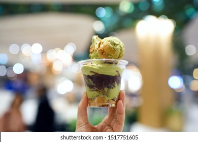 Green Tea Soft Serve - A Cup Of Matcha Ice Cream Topped With Red Bean And Choux Cream On Blurred Background, Traditional Japanese Confectionery.