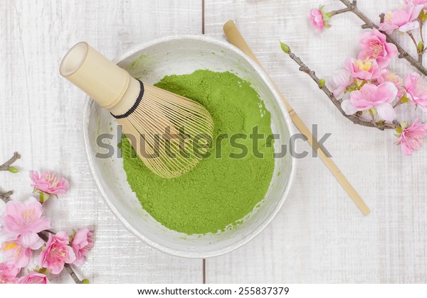\
Green  tea . Still life with green tea powder and bamboo whisk.\
Japanese Tea Ceremony: Preparation of powdered green\
tea