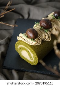 Green Tea Swiss Roll Cake With Chestnut Cream Filling Set On Cafe Table.