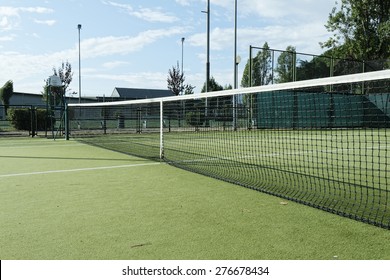 green tennis court in the town of la spezia